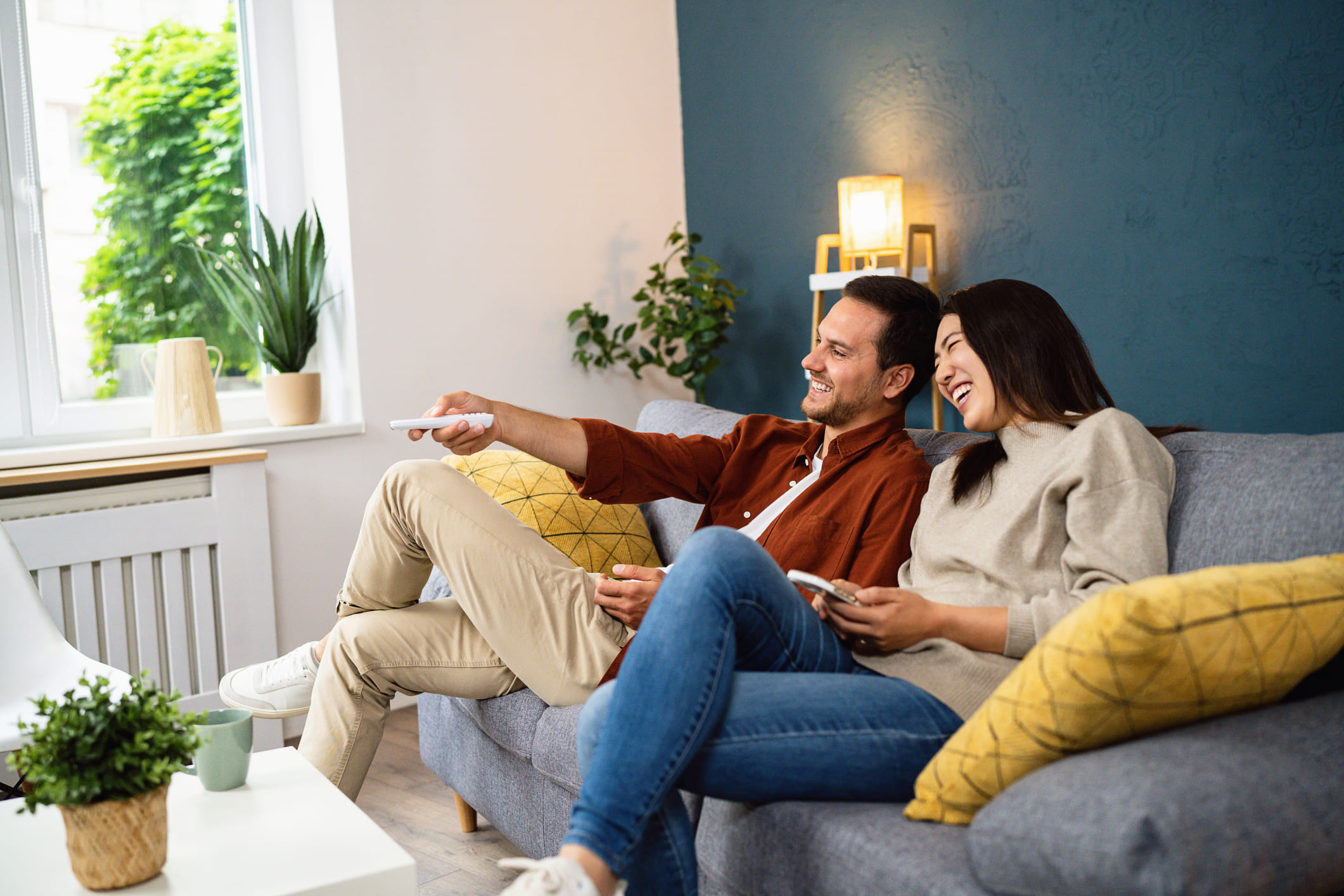 A couple watching TV in their living room
