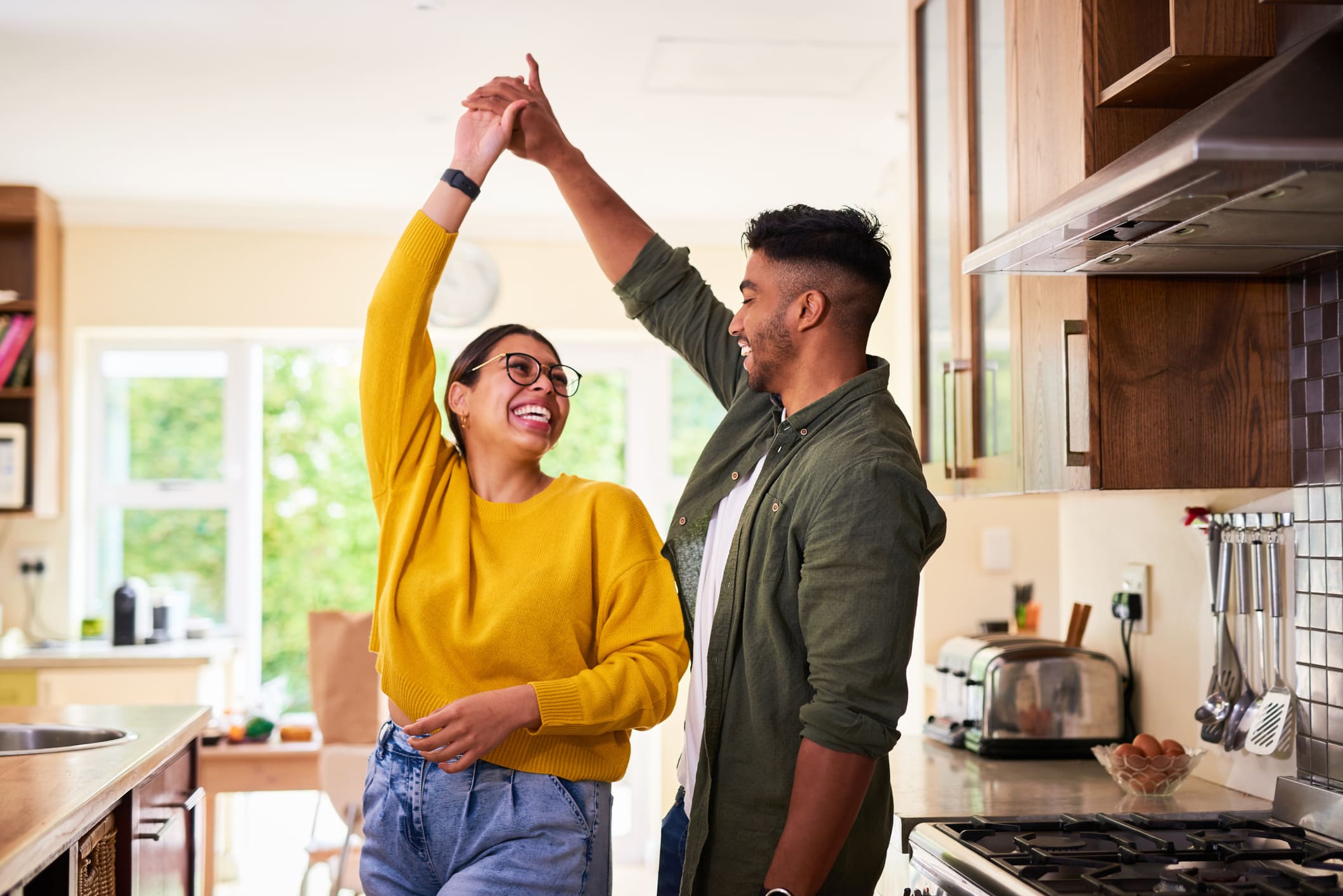 A man and woman dancing in their living room